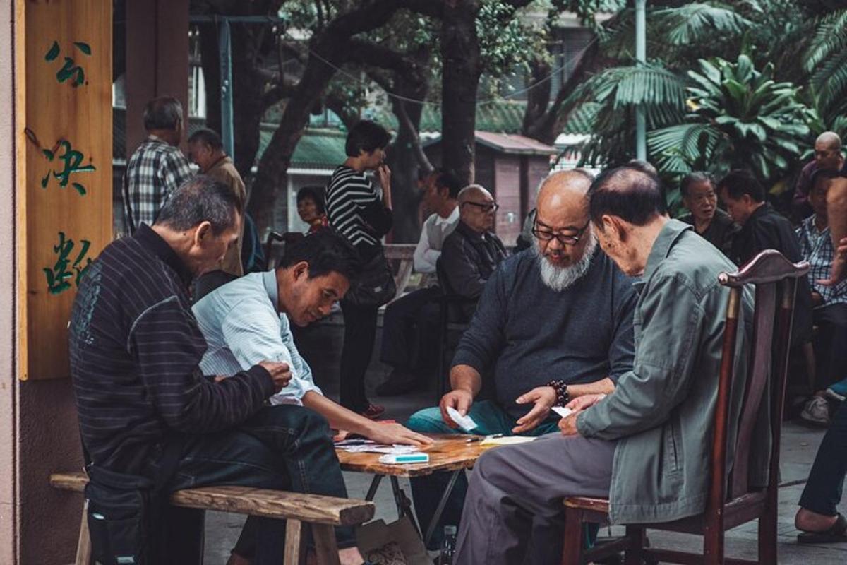 a group of men sitting around a table playing cards