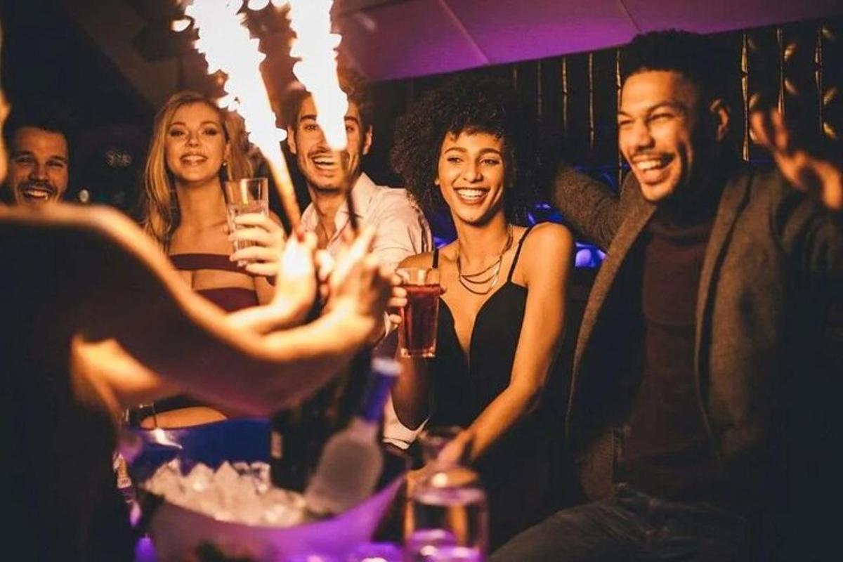 un gruppo di persone a una festa che tengono in mano bicchieri di vino