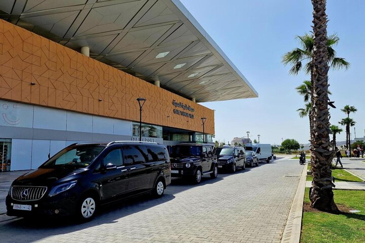a line of cars parked in front of a building