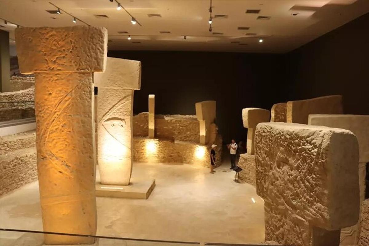 a museum exhibit with stone ruins in a room