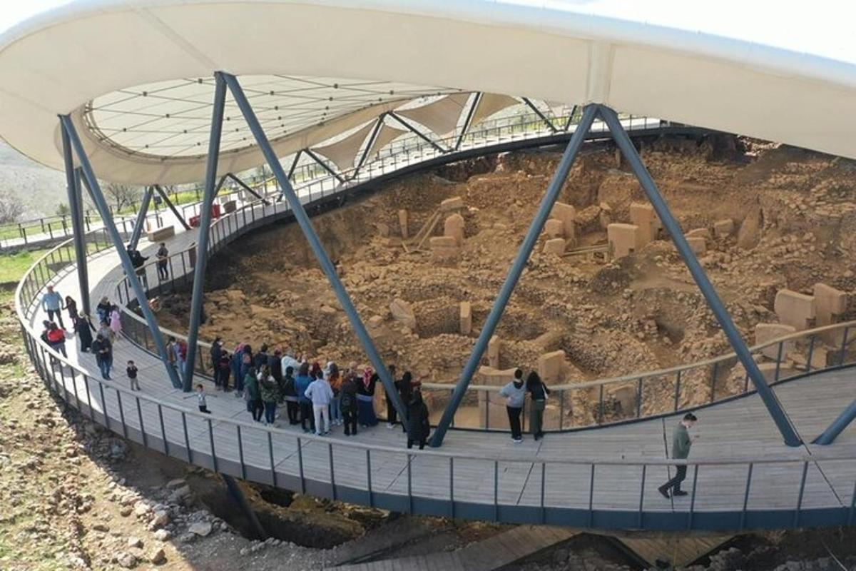 a group of people standing on a walkway under a bridge