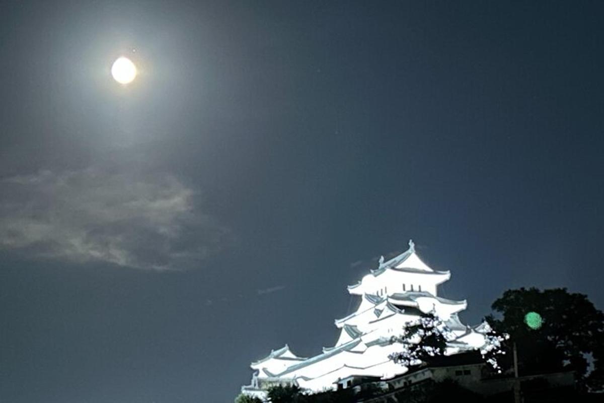 a white building with the moon in the sky