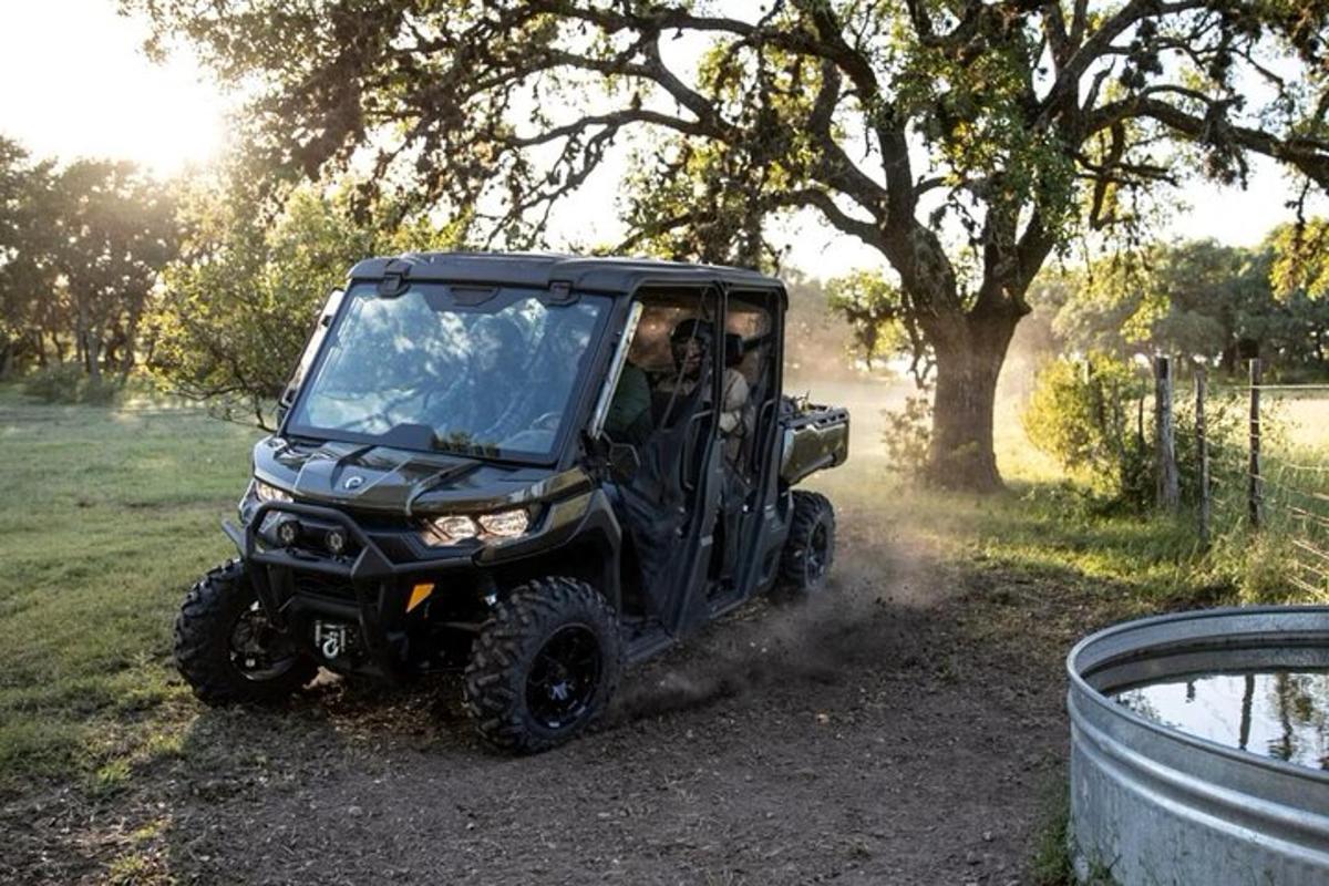 a black atv driving down a dirt road