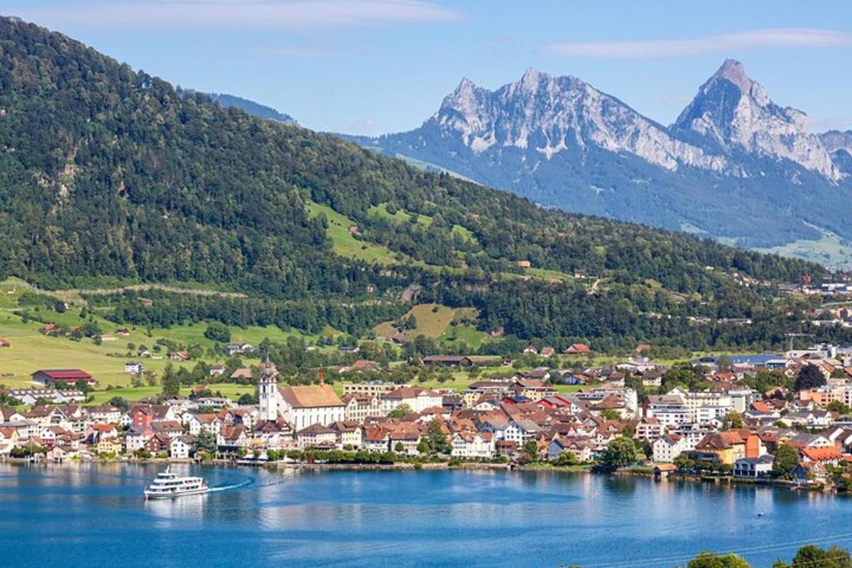 a town on a lake with mountains in the background