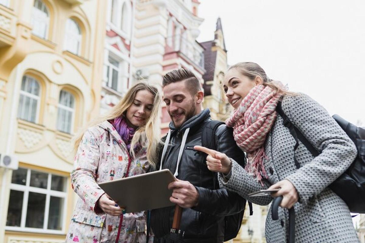 a group of three people looking at a laptop