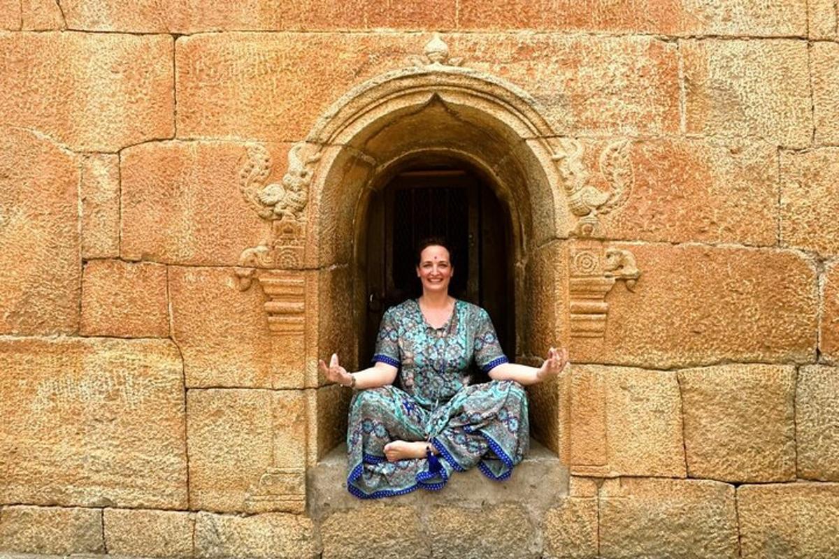 a woman sitting in a window of a building