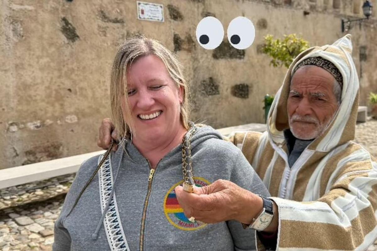 an older woman is smiling while looking at her watch