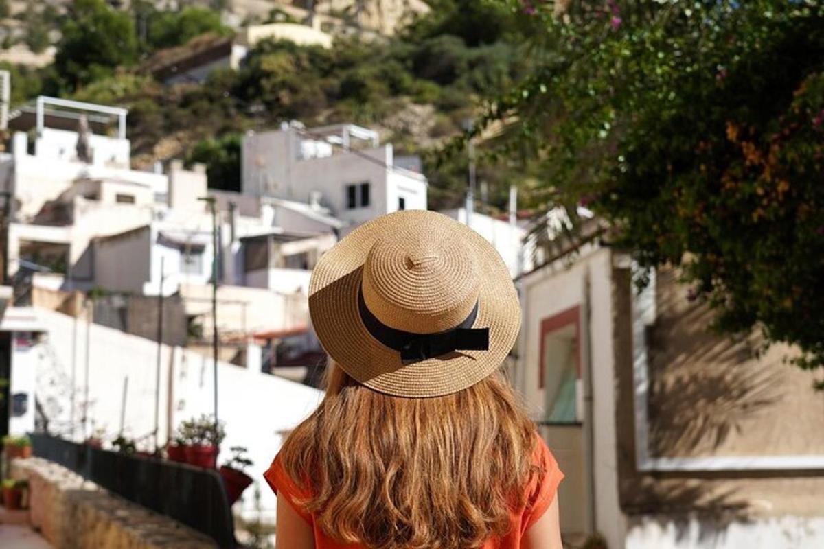 a woman wearing a straw hat with a black bow tie