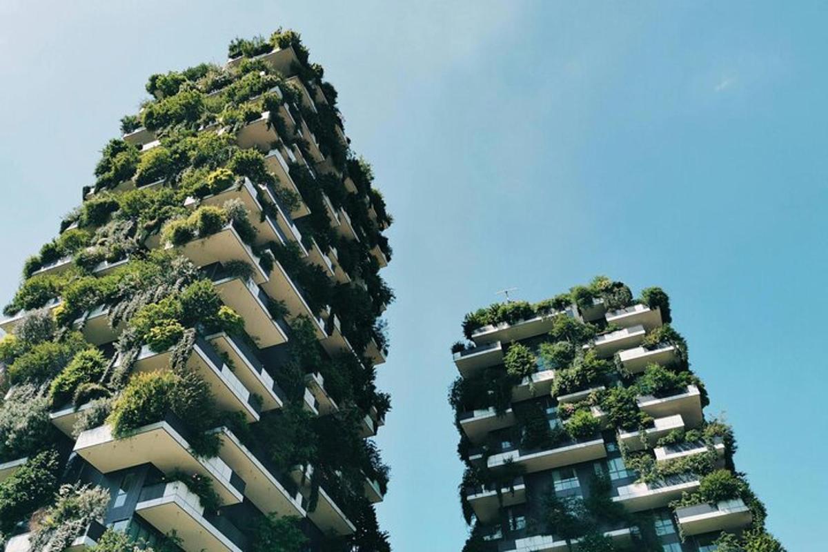 two tall buildings with plants on them