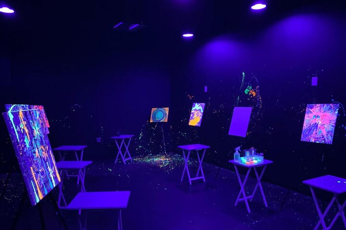 a stage with purple chairs and tables in a dark room