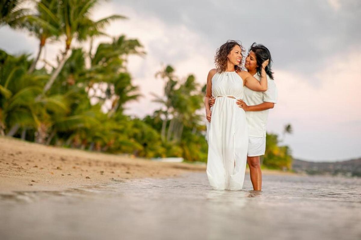 two women standing in the water on a beach