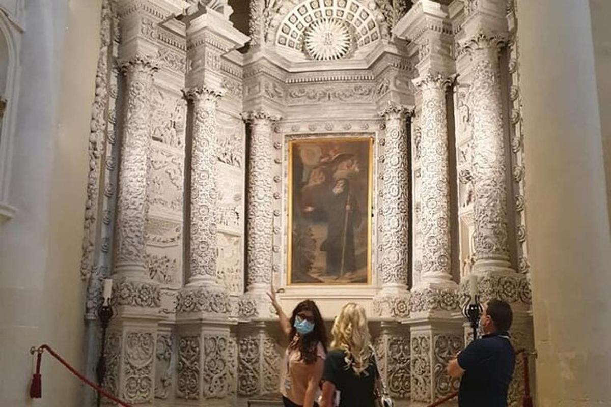 un grup de persones dretes davant d'una pintura