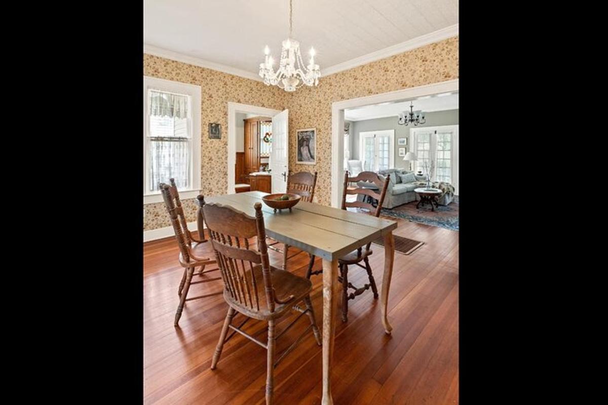 a dining room and living room with a table and chairs