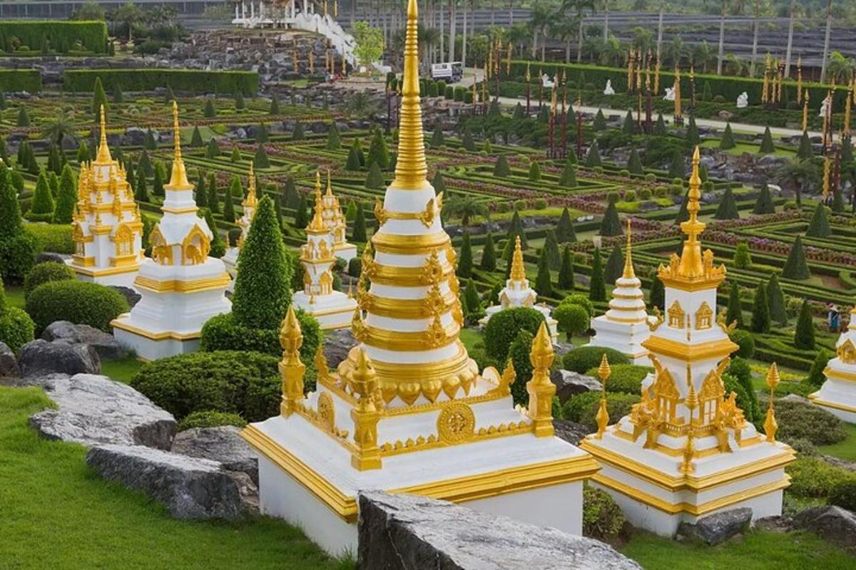 a group of gold and white pagodas in a garden
