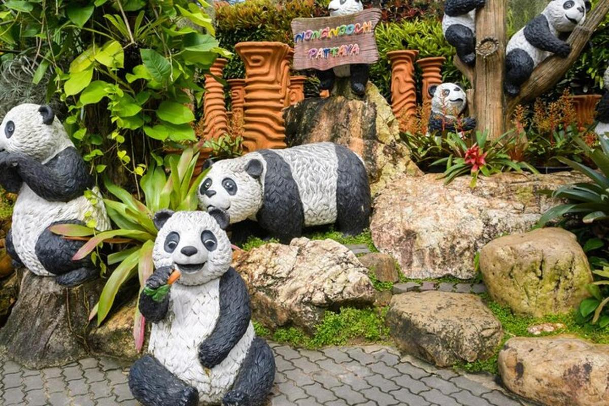 a display of stuffed panda bears in a garden
