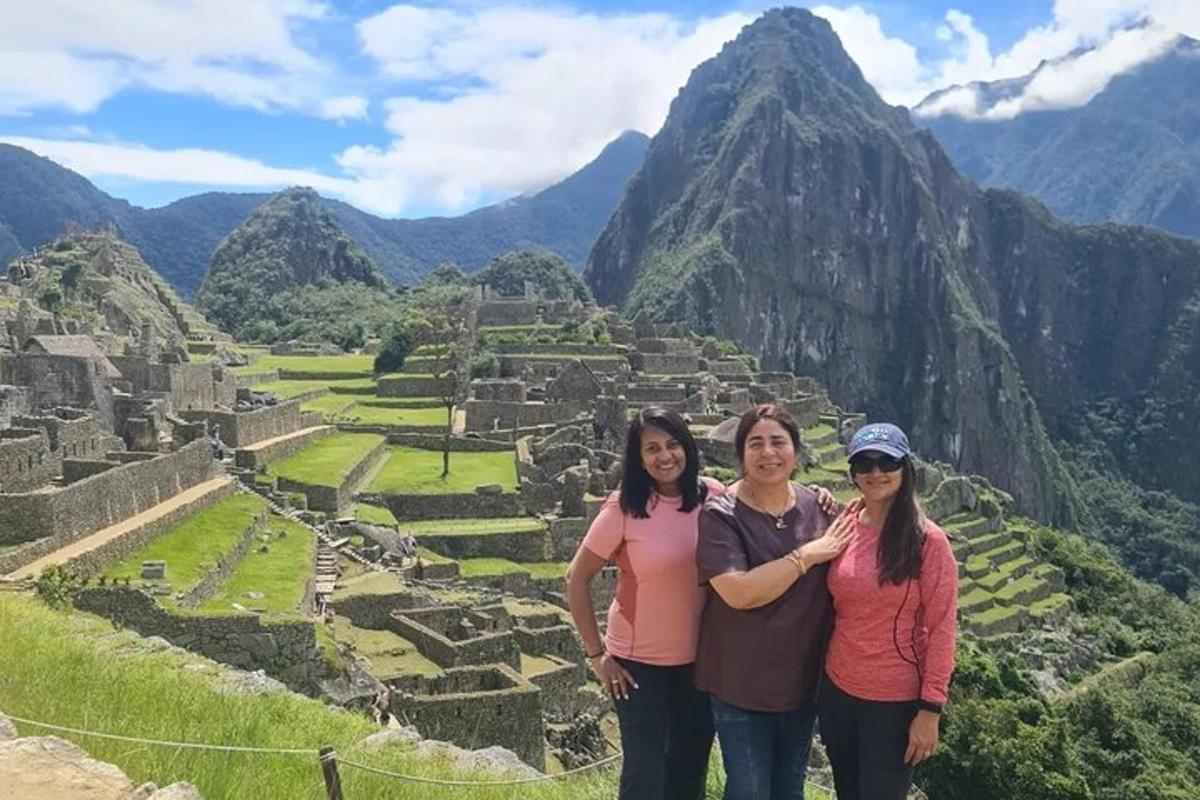 a group of people standing in front of the ruins of a mountain