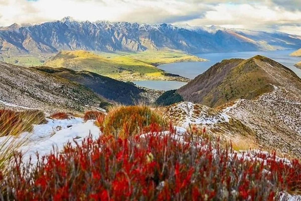 a view of a mountain with snow and a lake