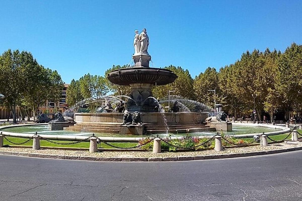 a fountain with a statue in the middle of a park