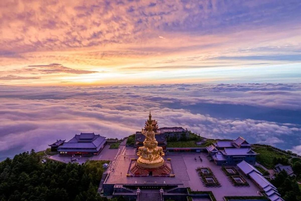 a view of a pagoda in the sky above the clouds