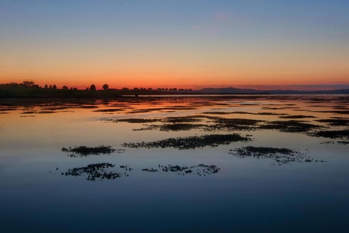 a sunset over a large body of water