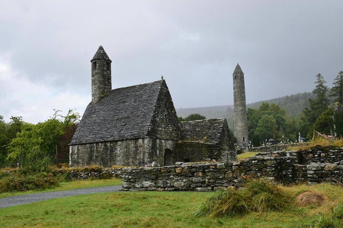 an old stone building with two towers on a field