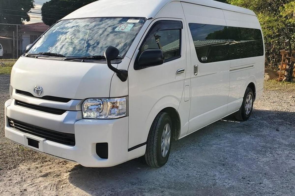 a white van parked in a gravel lot