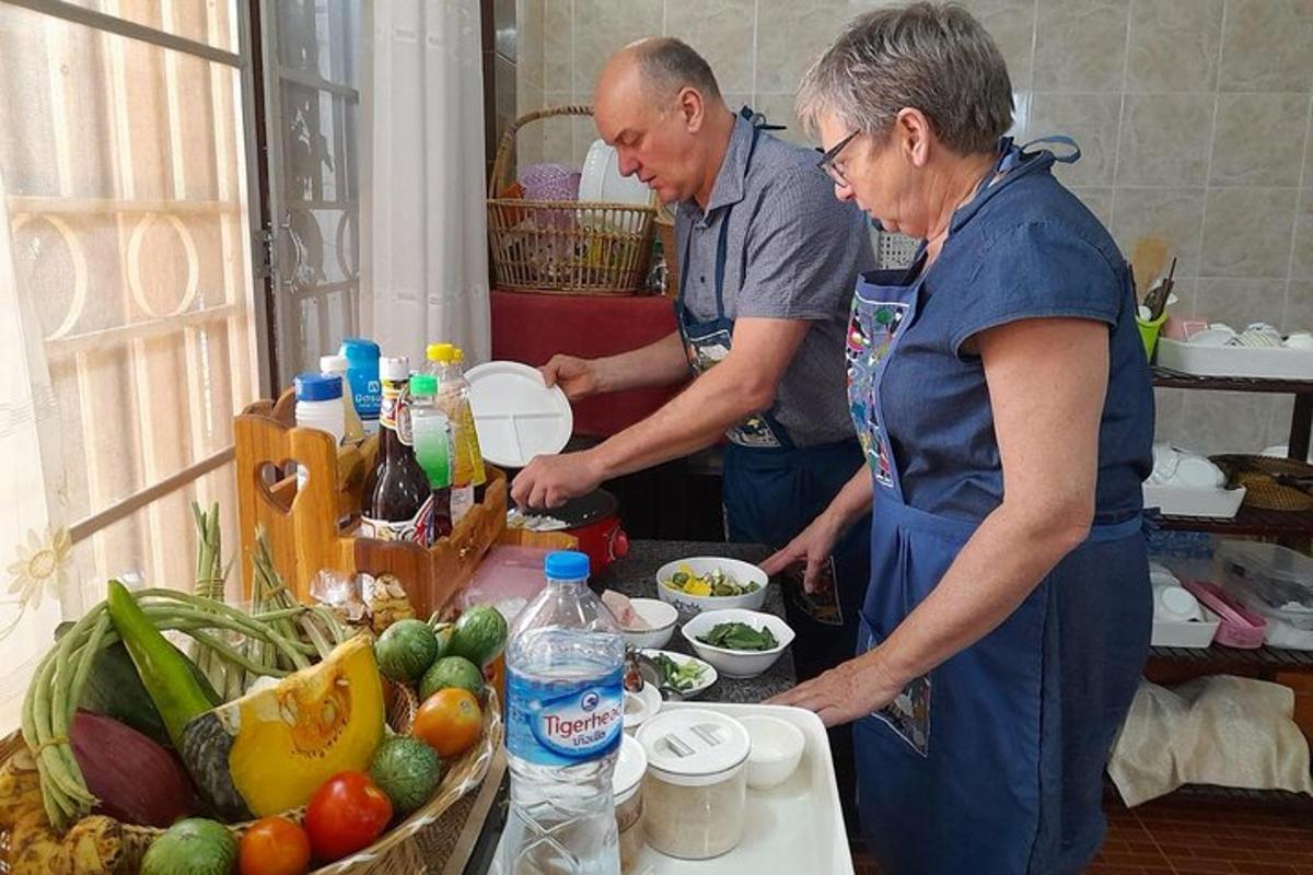 a man and a woman preparing food in a kitchen