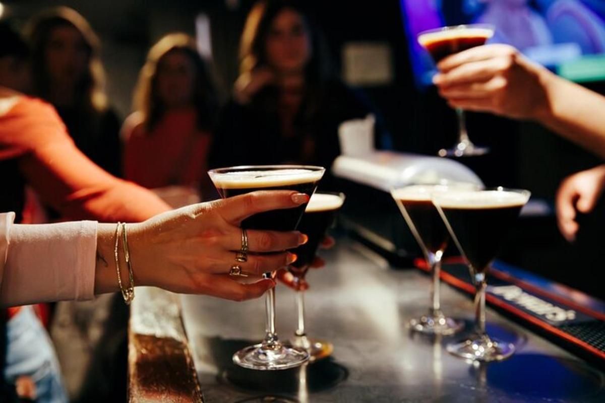 a group of people holding wine glasses at a bar
