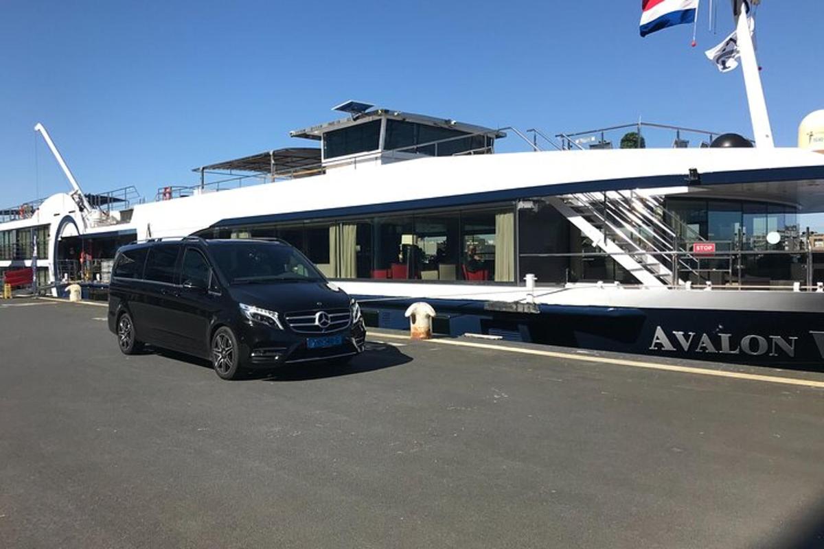 a black van parked next to a boat