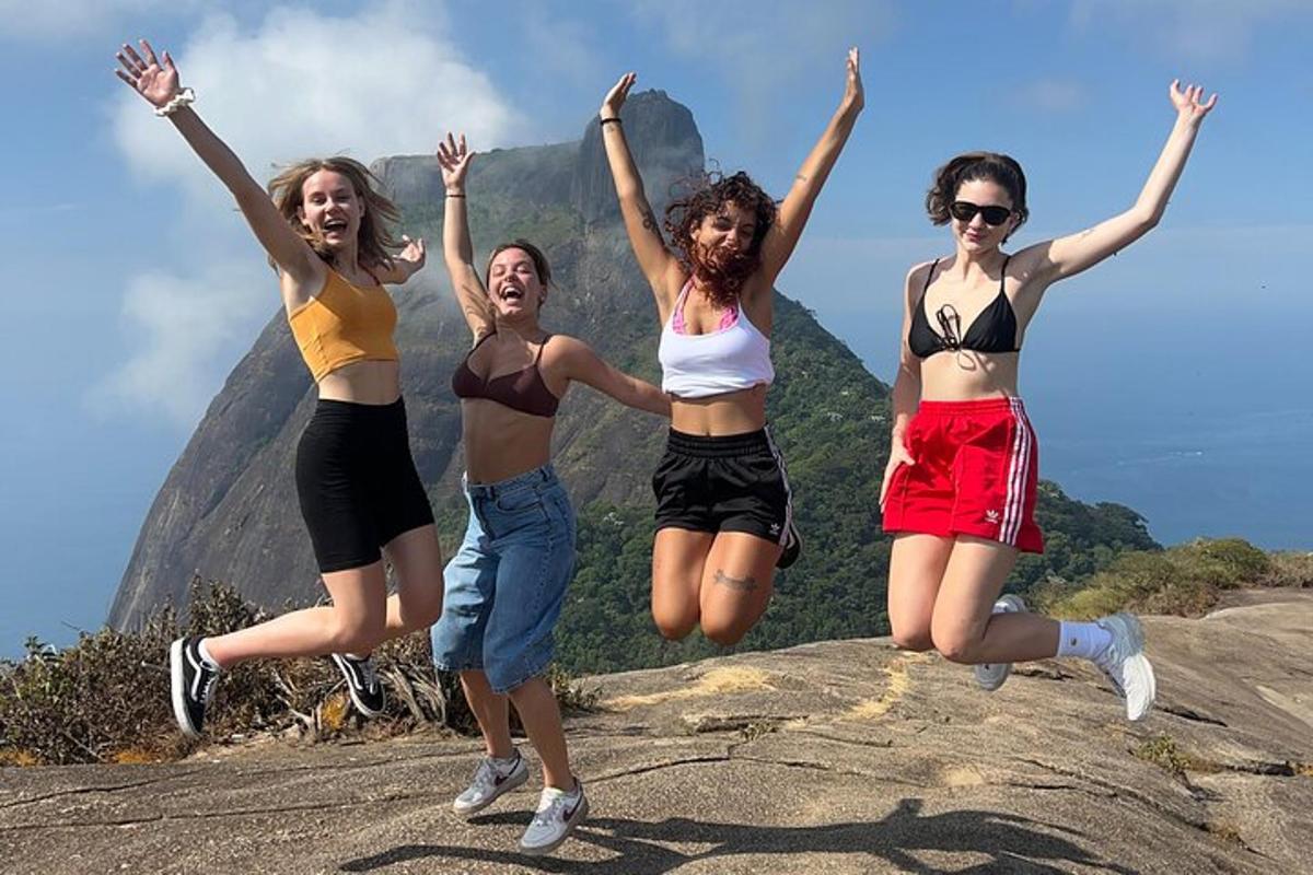 a group of girls jumping on top of a rock