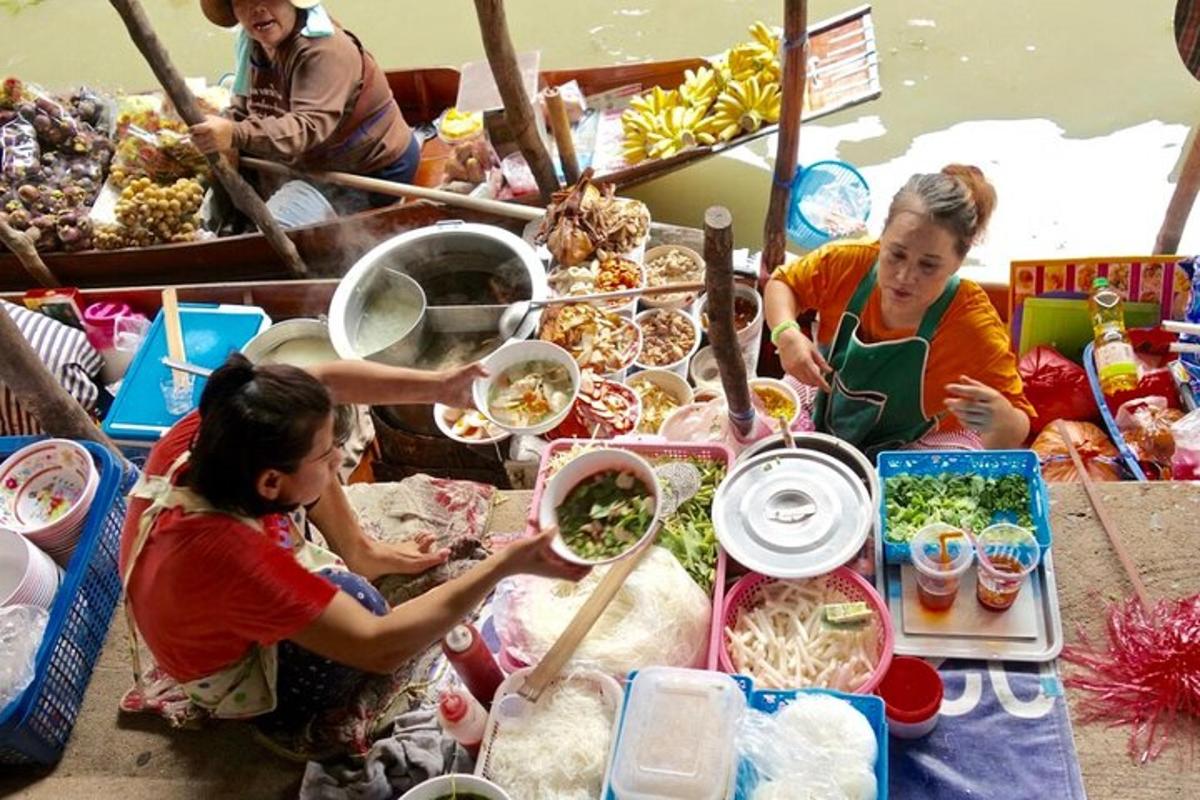 a group of people eating food on a boat