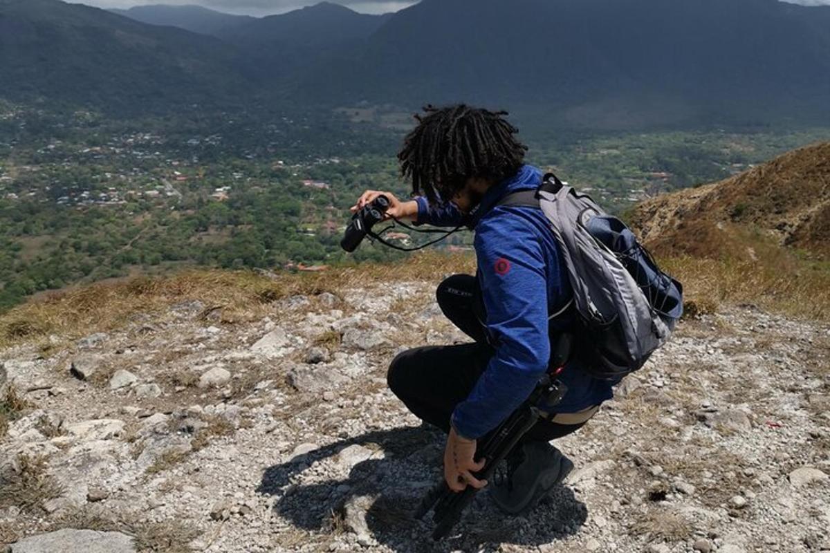 a person with a camera on top of a mountain