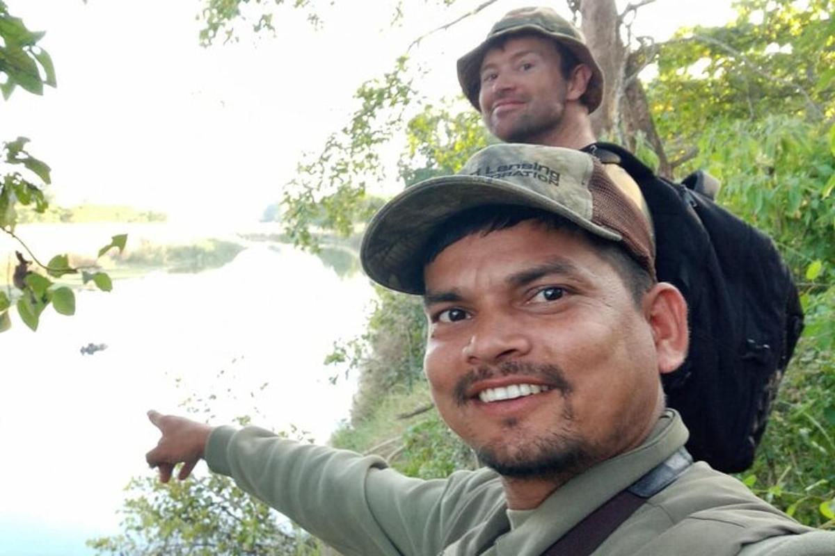 two men are standing in the woods with