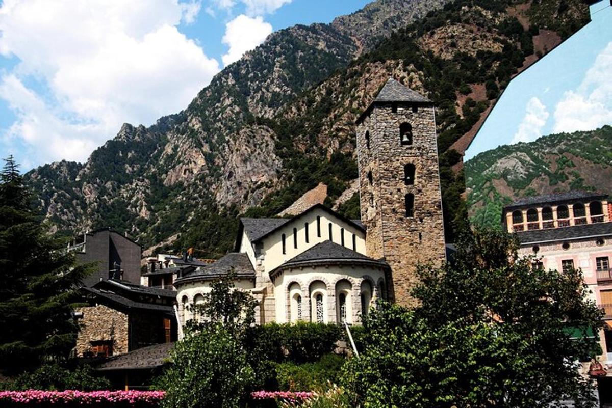 a building with a clock tower in front of a mountain