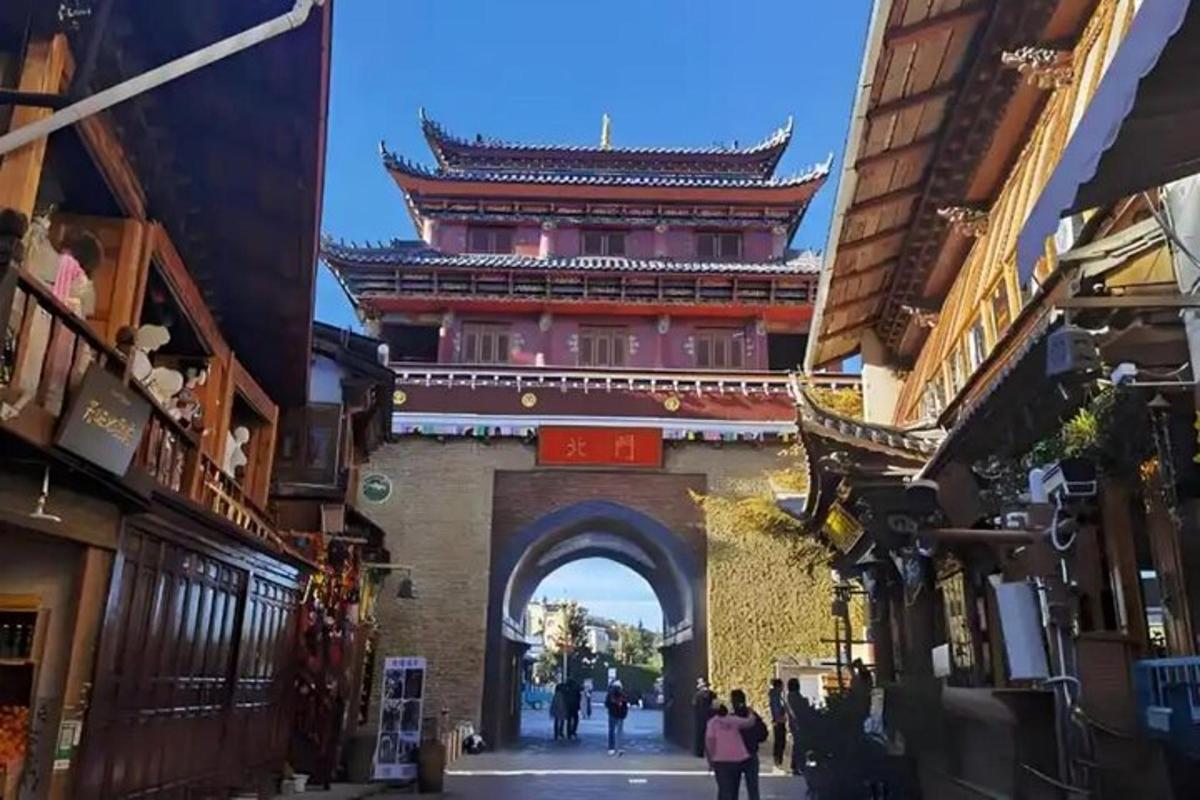 an archway in a city with a building behind it