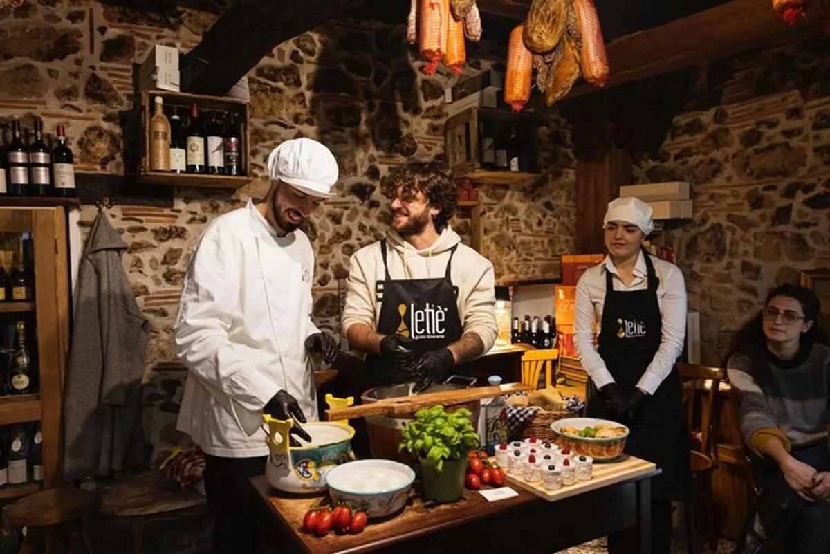 a group of chefs standing in a kitchen preparing food