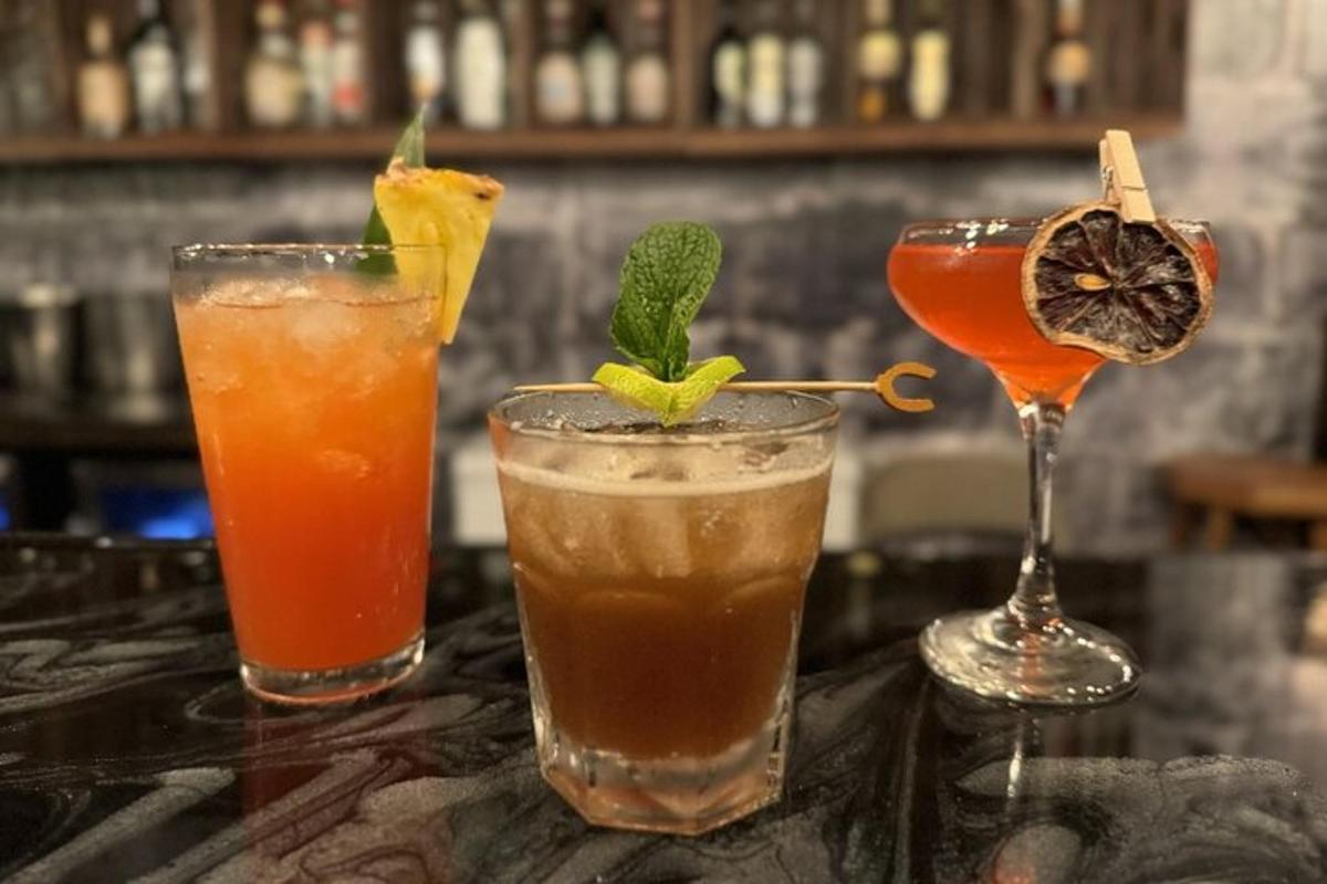 três coquetéis em uma mesa em um bar