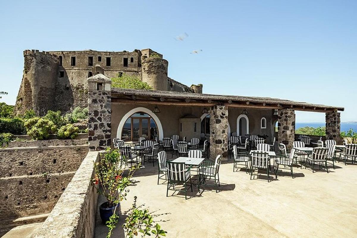 a patio with tables and chairs in front of a building