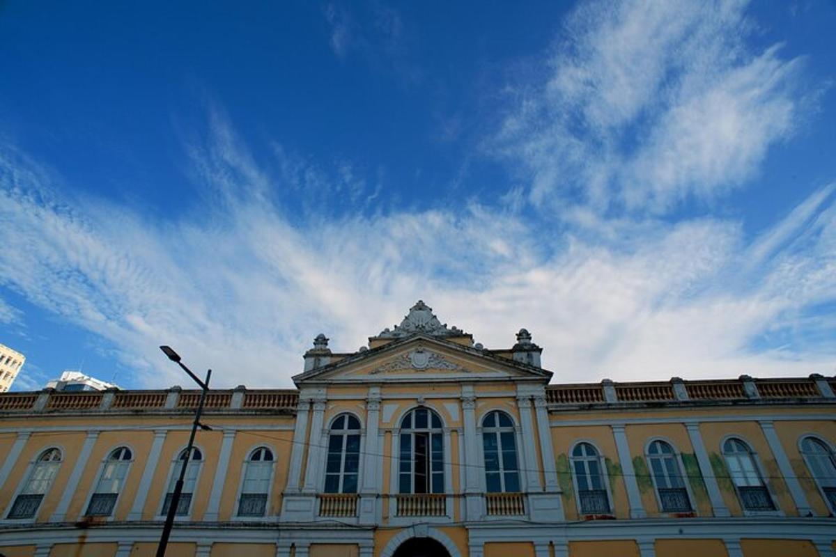 a large building with a blue sky in the background