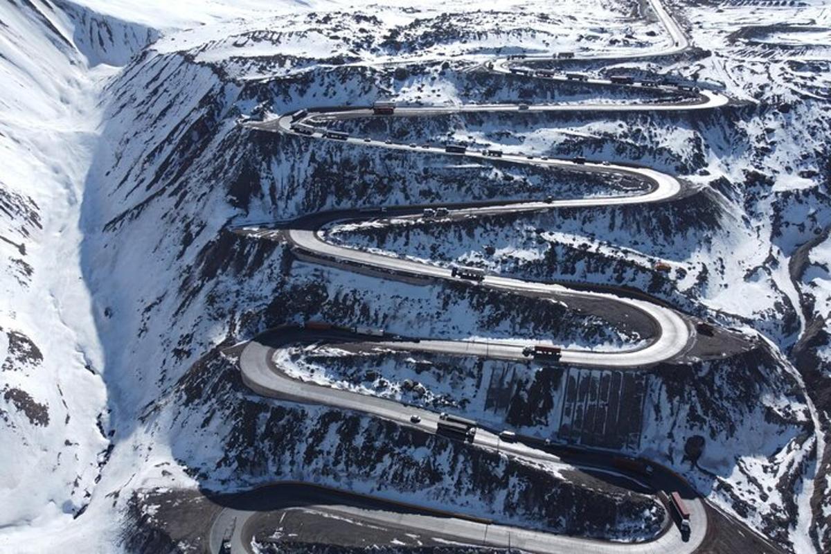 an aerial view of winding roads on a snowy mountain