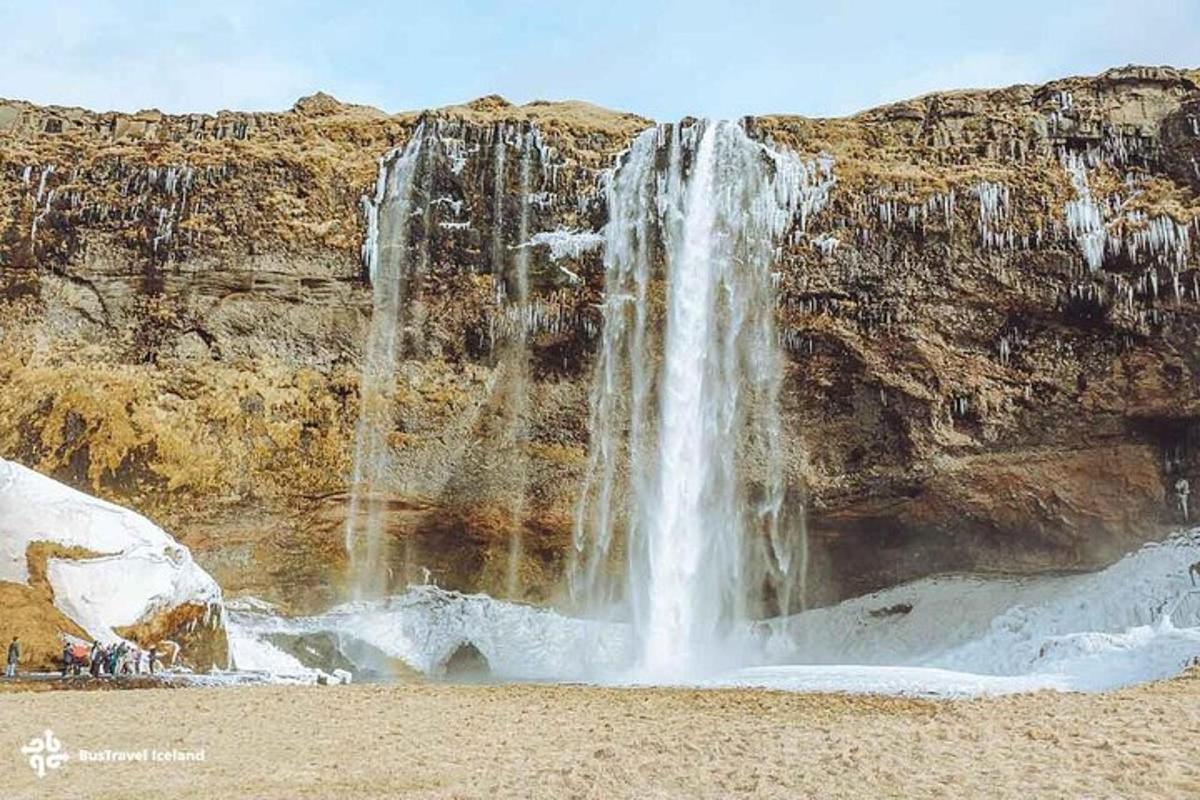 a waterfall on the side of a mountain