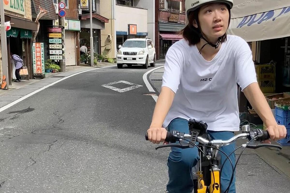 a woman riding a bike down a street