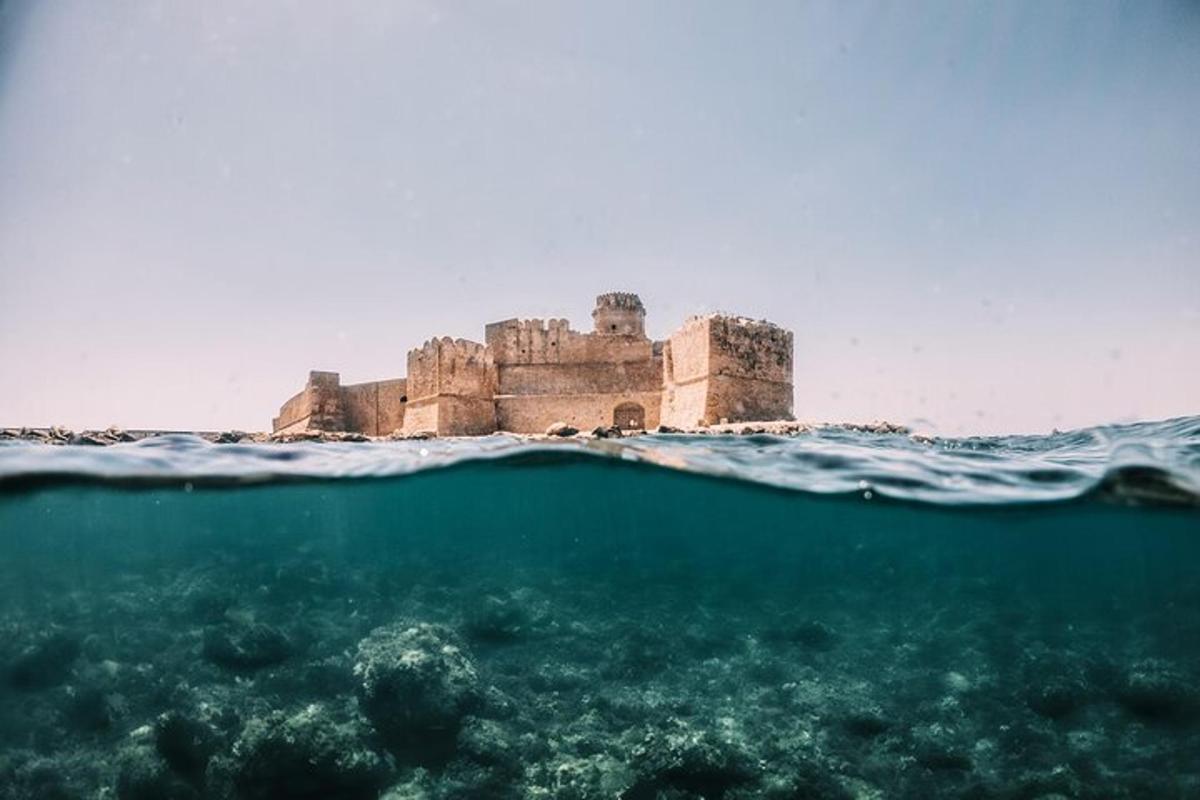 an island in the ocean in front of a body of water