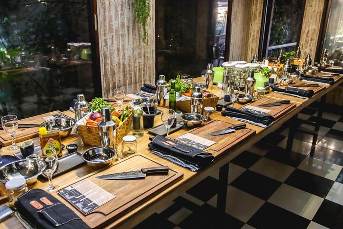 a long wooden table with bottles and glasses on it