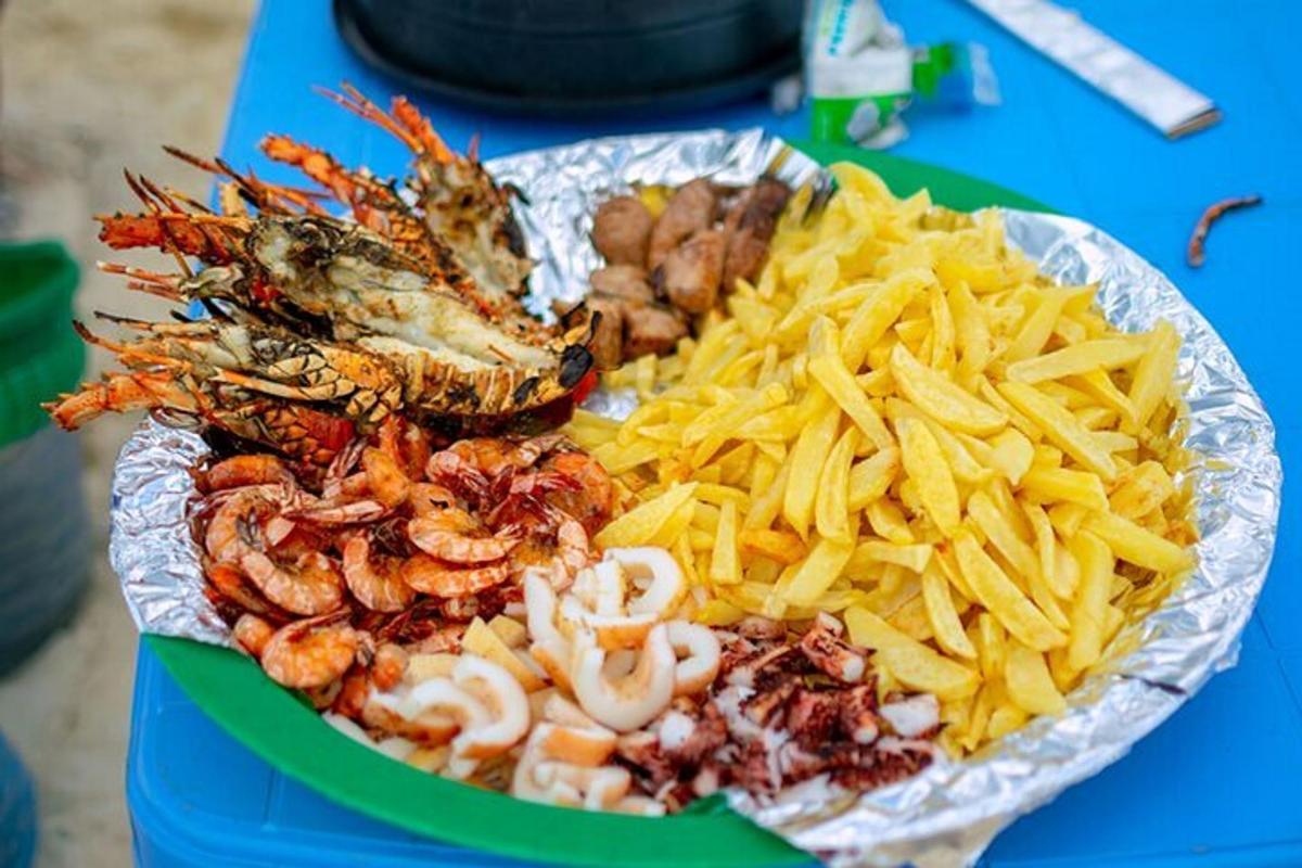 a plate of food with seafood and chips on a table