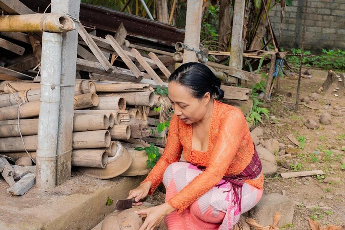 a woman sitting on the ground playing with a tool