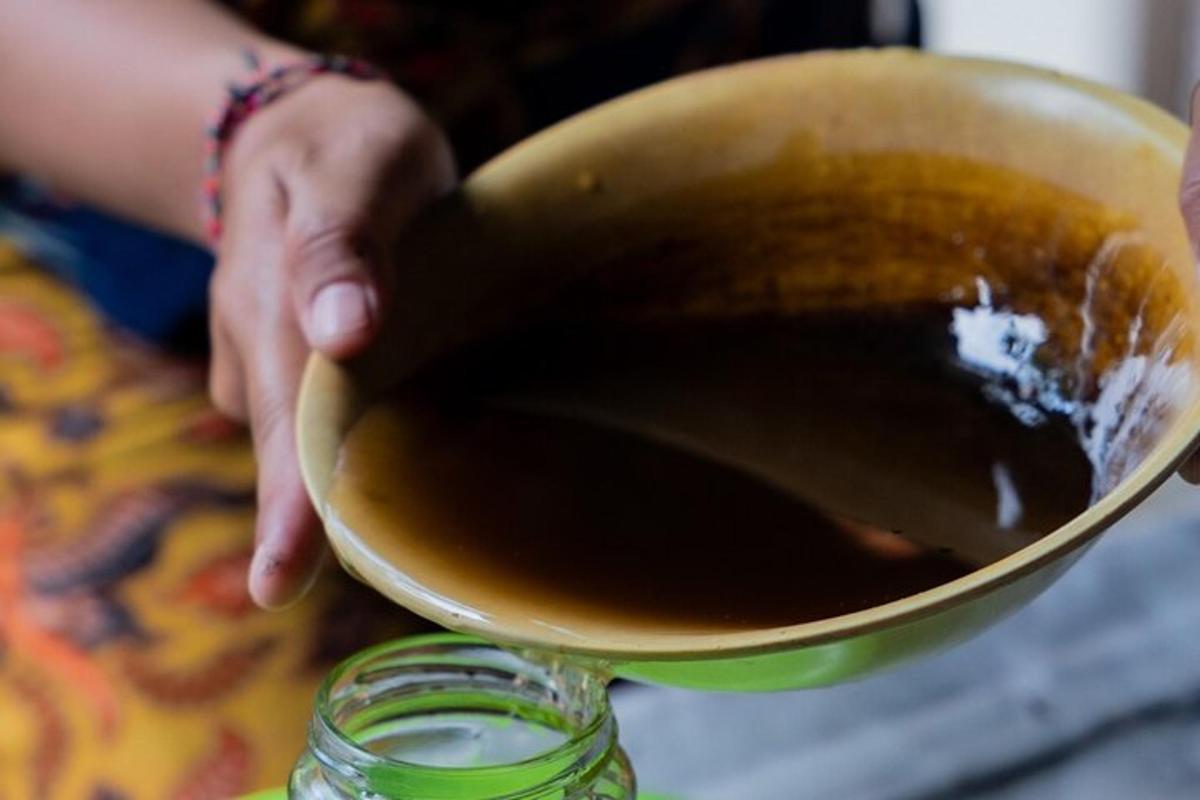 a person holding a bowl with liquid in it