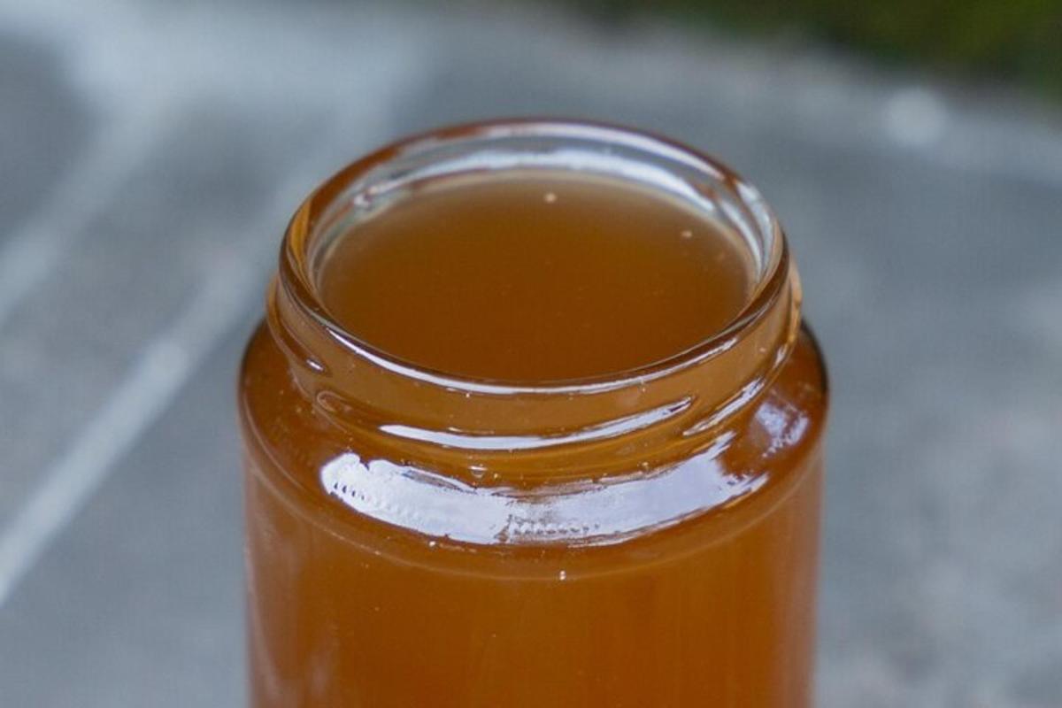 a jar of honey sitting on a table