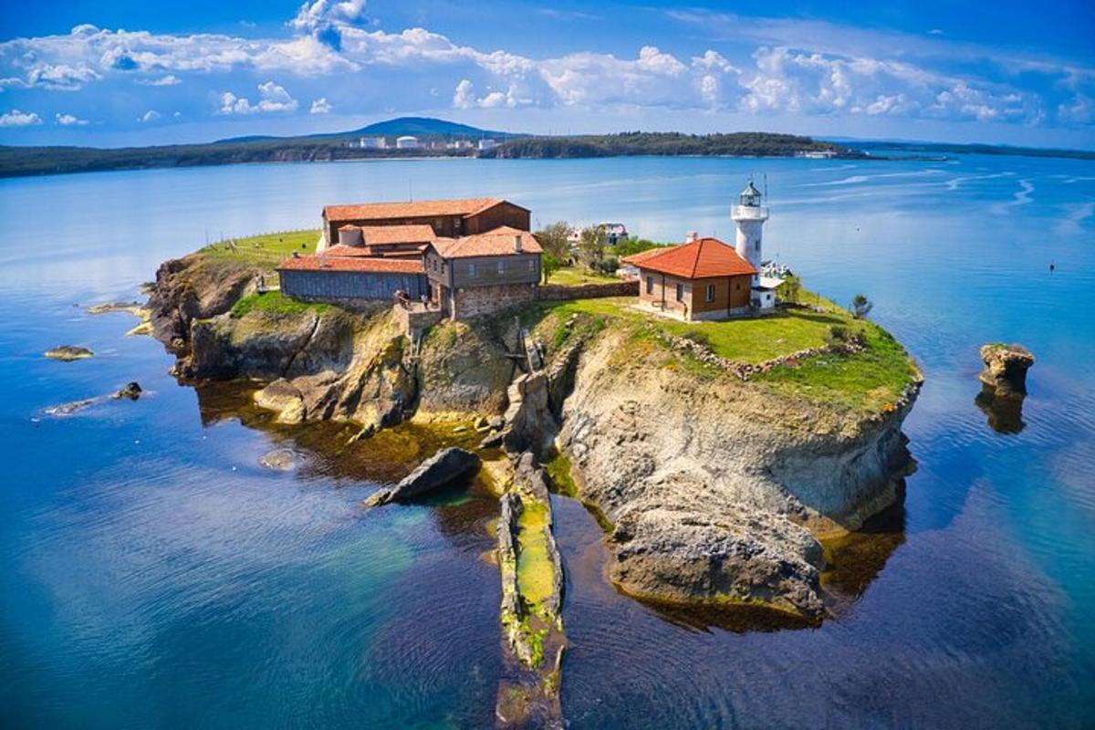 an island with a lighthouse on a body of water