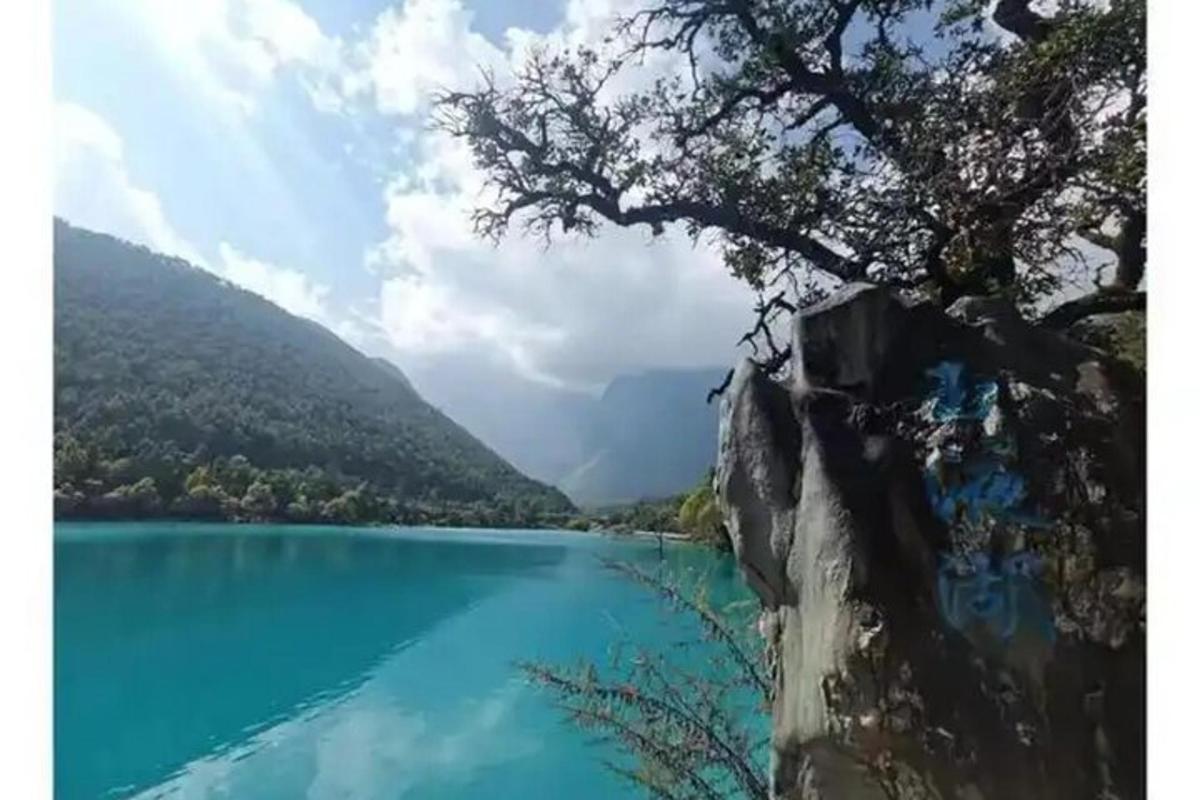 a view of a blue lake next to a mountain